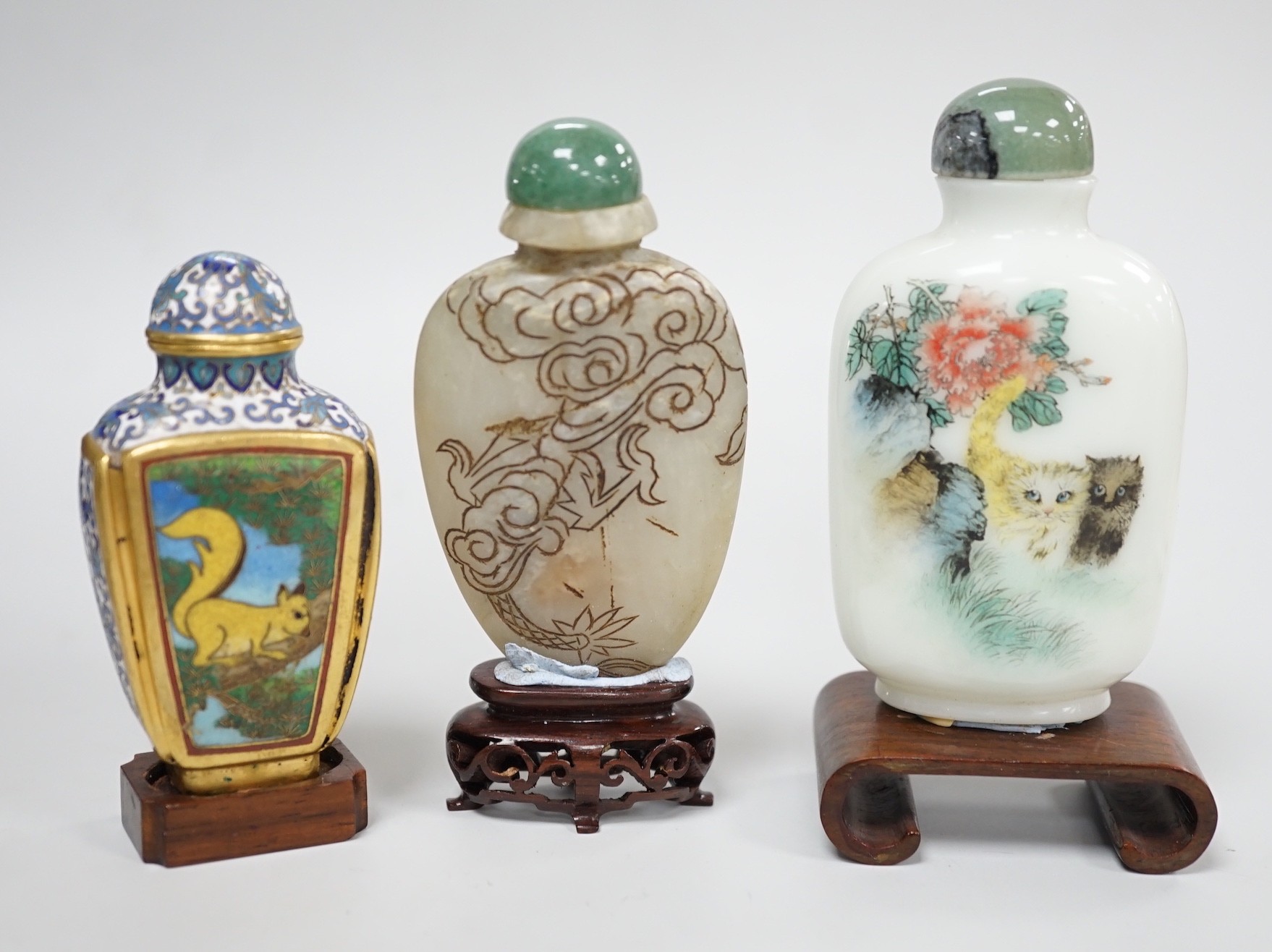 A Chinese cloisonné enamel snuff bottle, enamelled glass and stone snuff bottles. Tallest 8cm (3)